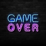 Game Over neon sign on brick wall.