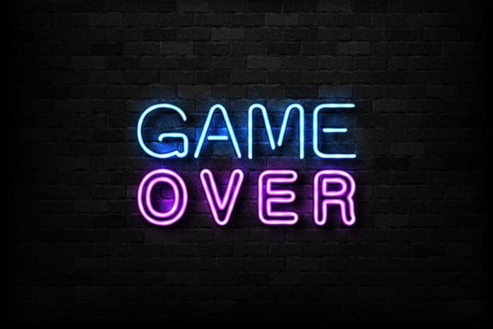 Game Over neon sign on brick wall.