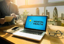 Laptop displaying Mental Health screen in an office