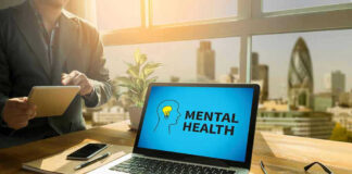 Laptop displaying Mental Health screen in an office