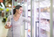 Plant-Based Promise SHATTERED by New Data A woman shopping in the frozen food aisle of a supermarket