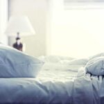 Sleep-Boosting Nut – Surprising Hidden Magic A cozy unmade bed with soft pillows and bedding in a well lit room