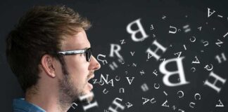Profile view of a man speaking with letters floating around him