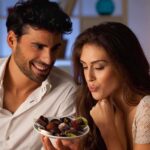 Gym Progress KILLER: The Meal Timing Mistake A couple sharing a plate of desserts in a cozy indoor setting