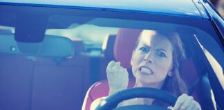 Angry woman gripping the steering wheel in a car